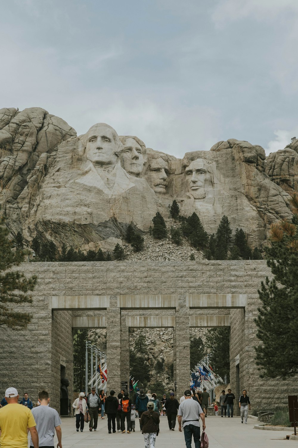 a group of people walking in front of a mountain