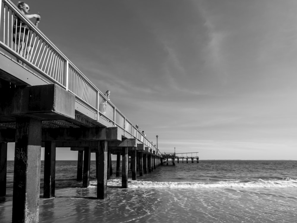 a black and white photo of a pier