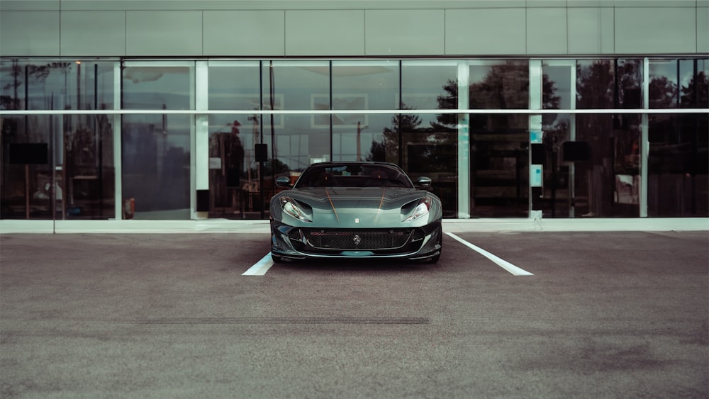 a black sports car parked in a parking lot