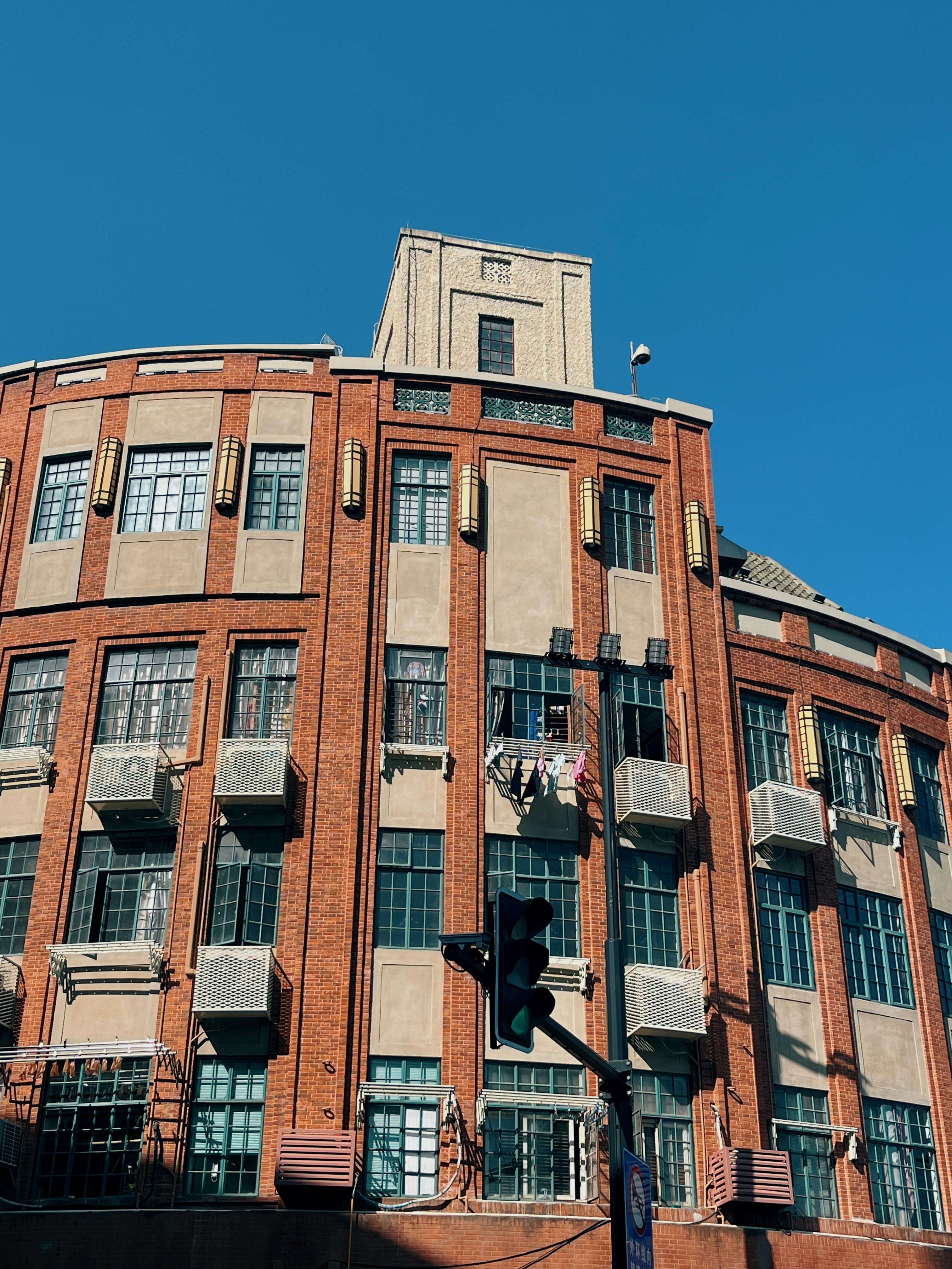 A tall brick building with lots of windows photo – Free Building Image ...