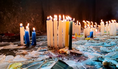 An array of artisanal candles in various colors and shapes.