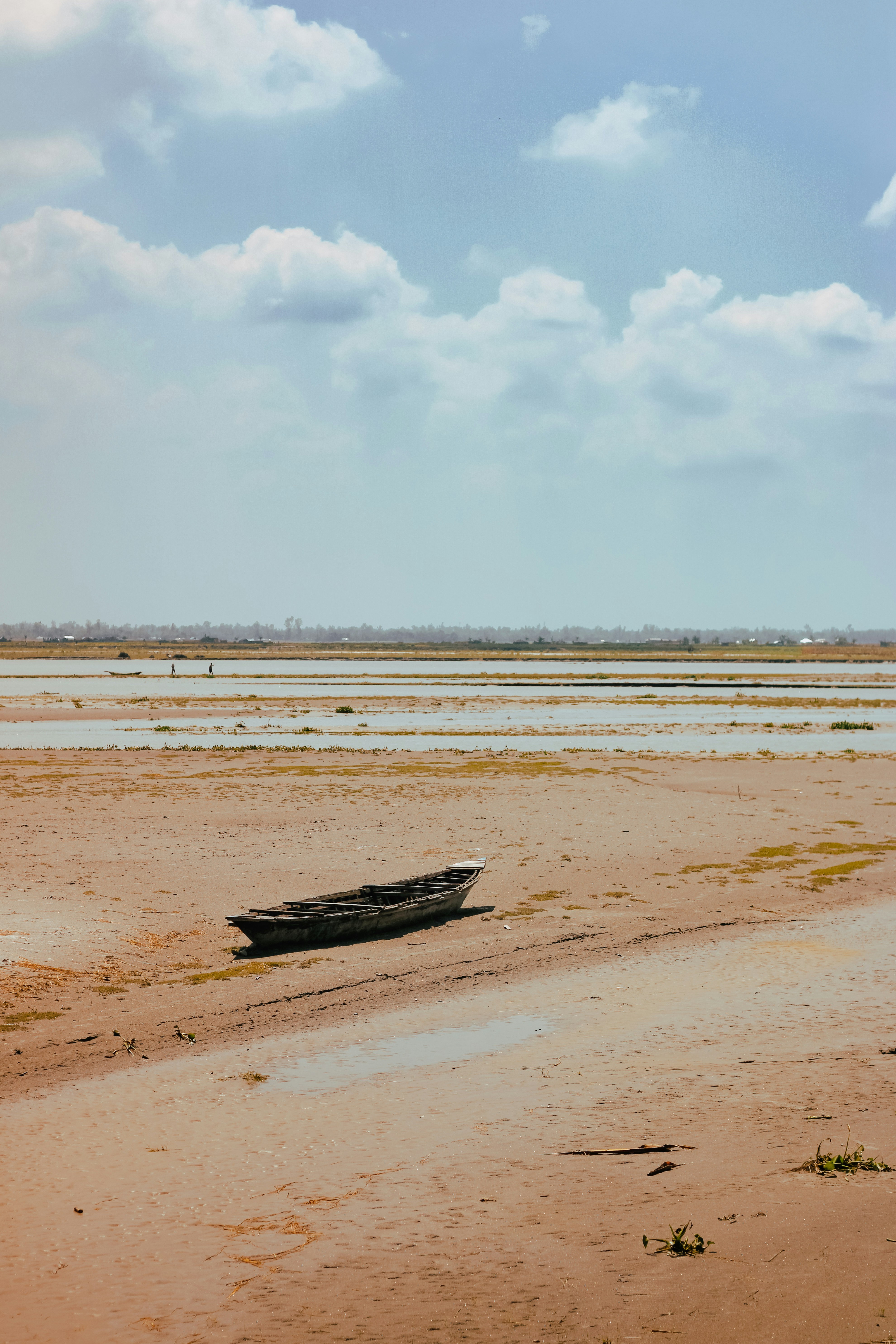 a boat sitting on top of a sandy beach