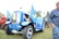 A satisfied customer standing next to a Valtra BM 110 tractor.