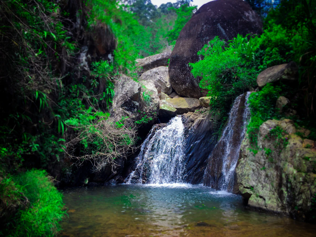 Waterfall and green hills in Sri Lanka's highlands