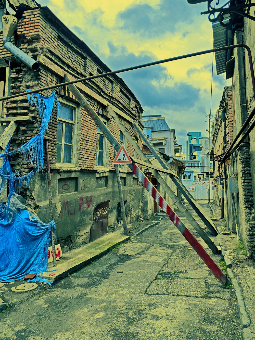 a blue tarp covering a street next to a building