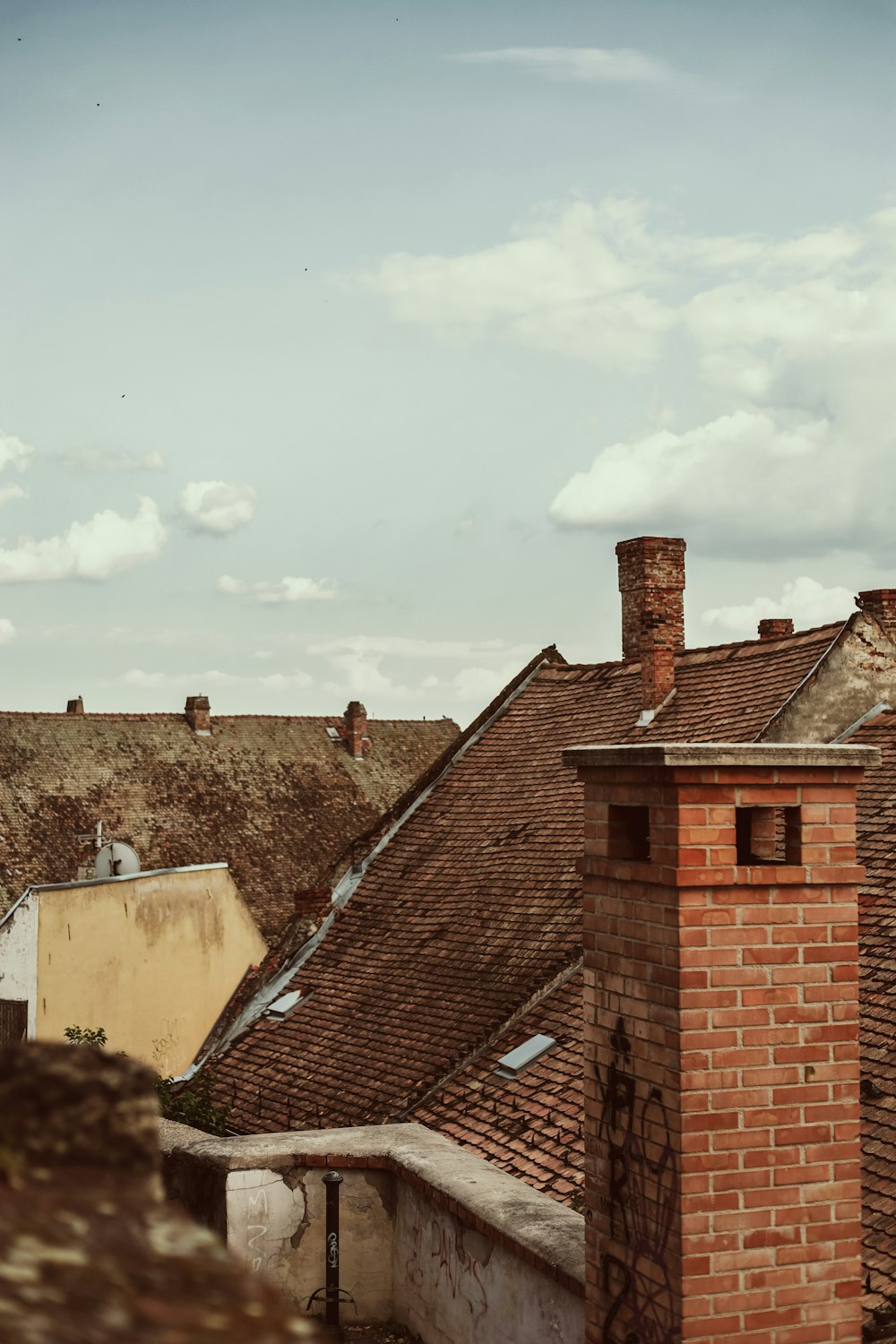 a view of rooftops with a sky background