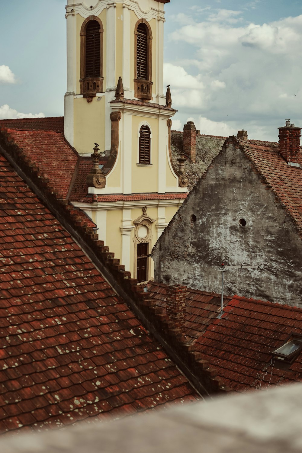 a church steeple with a clock tower in the background