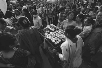 A vibrant photo showcasing a diverse group of women, men, and children wearing Just Jo Apparel in a sunlit urban setting.