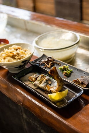 A traditional Japanese meal showcasing fresh vegetables, fish, and rice.
