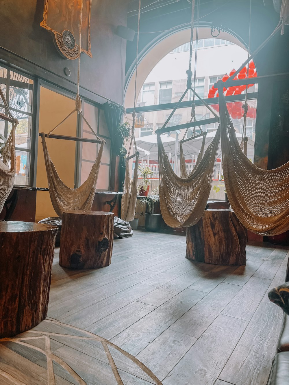 a room with hammocks hanging from the ceiling