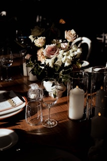 A beautifully arranged wedding table setting with elegant floral centerpieces and soft candlelight.
