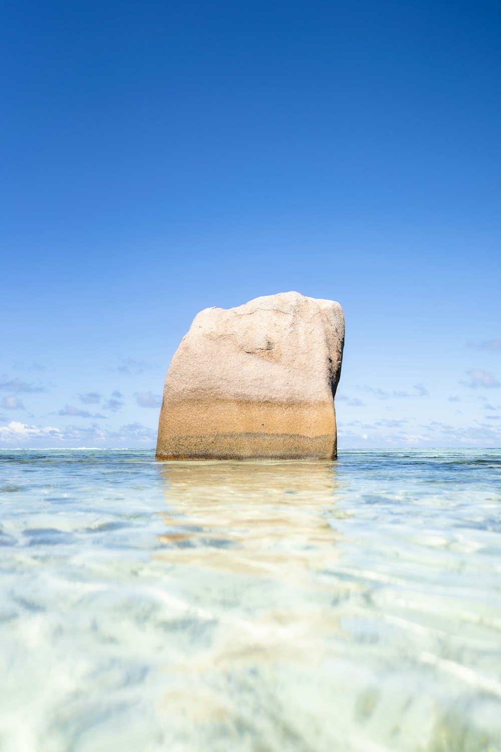 a large rock sticking out of the water