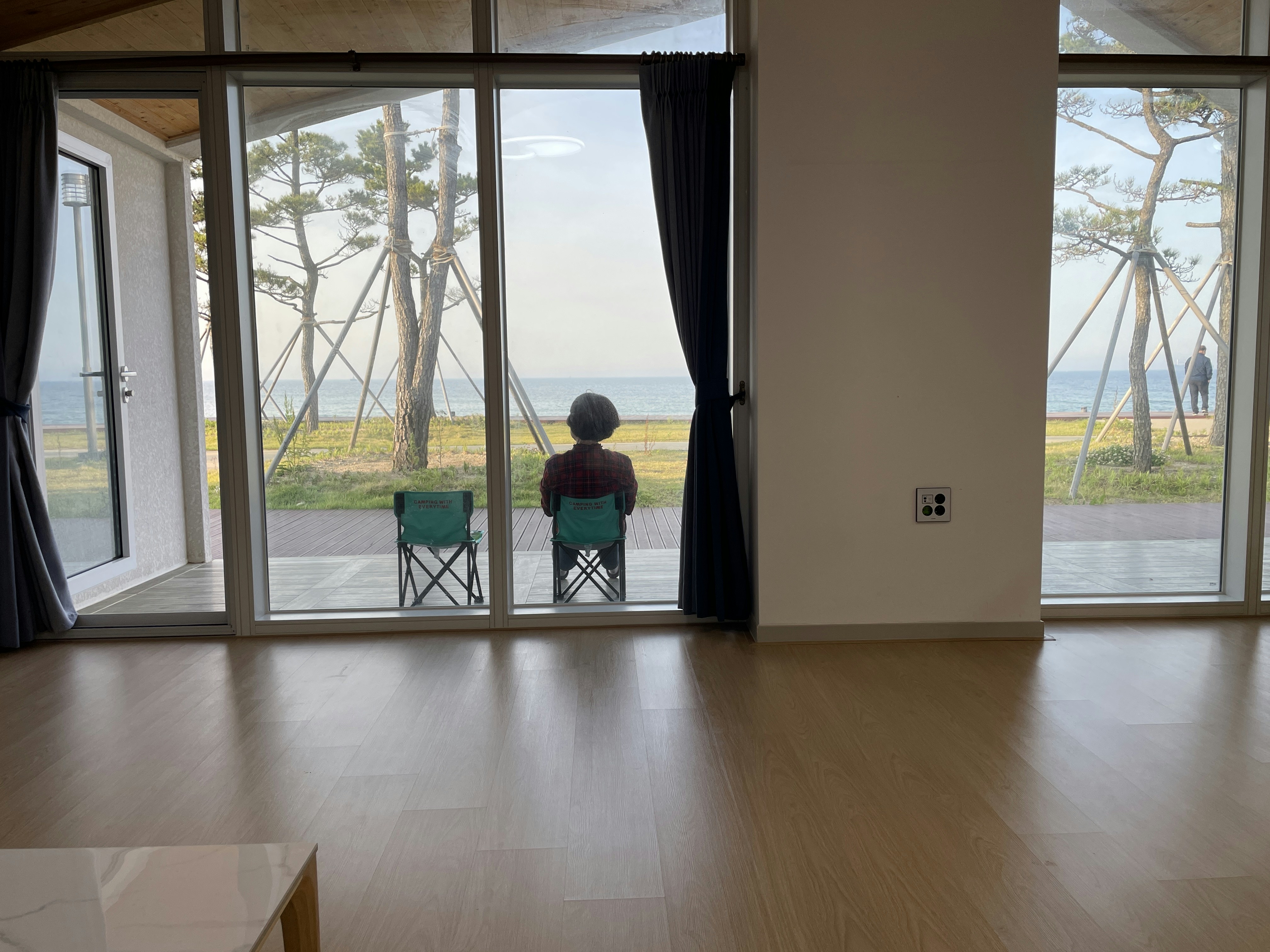 A person sitting in a chair looking out a window photo – Free Interior ...