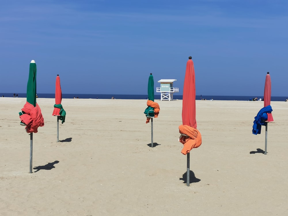 a bunch of umbrellas that are in the sand