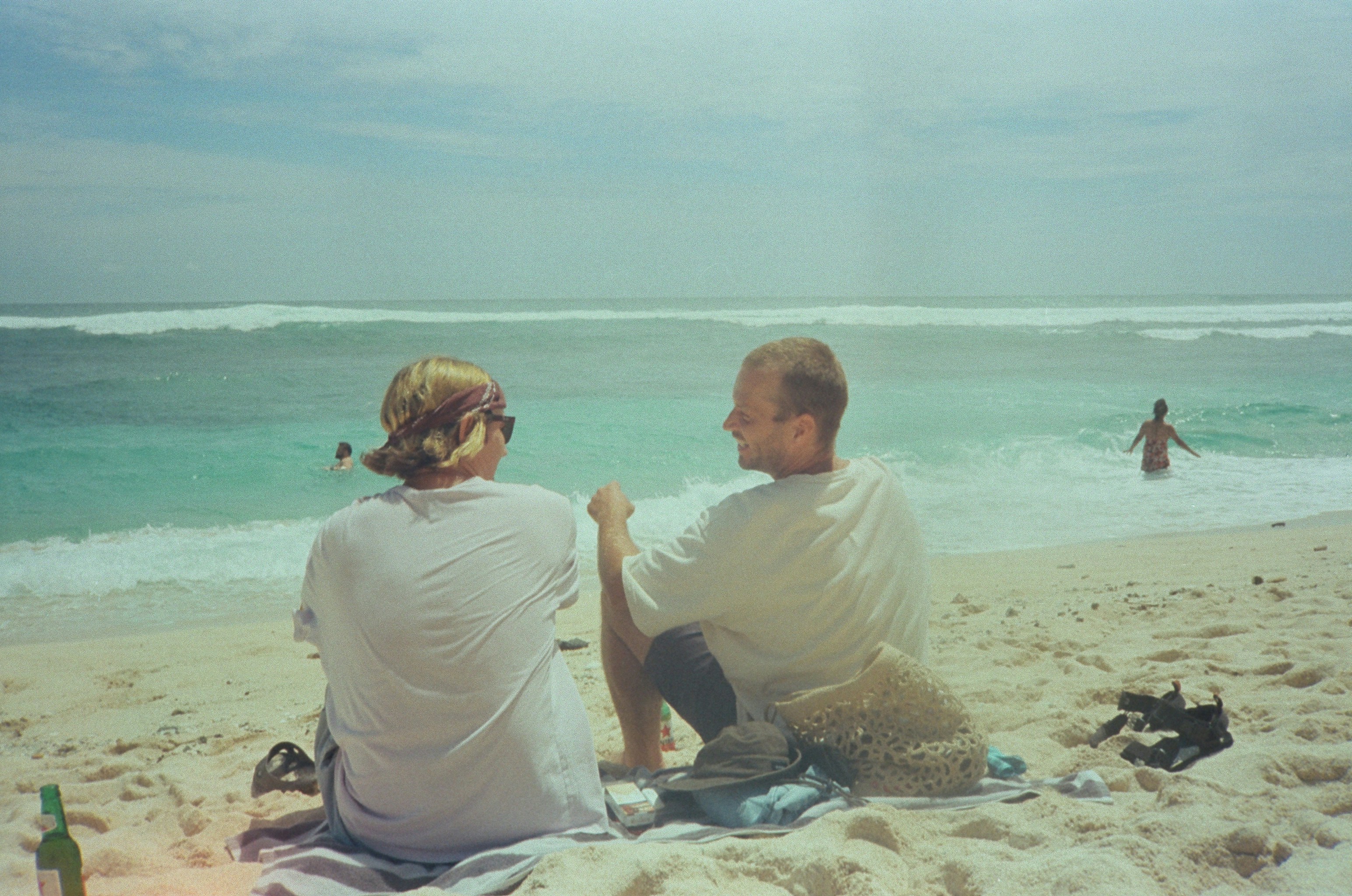 couple relaxing on a white-sand beach in the Caribbean - inexpensive romantic vacations