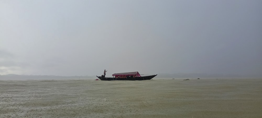 a small boat floating on top of a large body of water