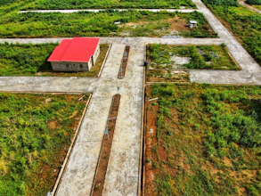 an aerial view of a farm with a red roof