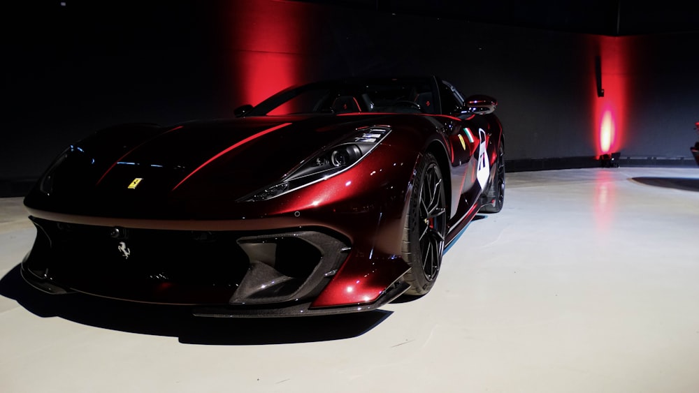 a red sports car on display in a showroom