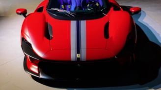 Side profile of a lowered street car with a bold red stripe racing down the side.