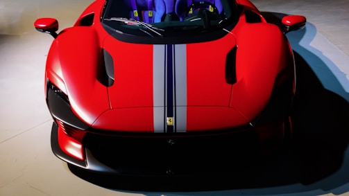 Side profile of a lowered street car with a bold red stripe racing down the side.