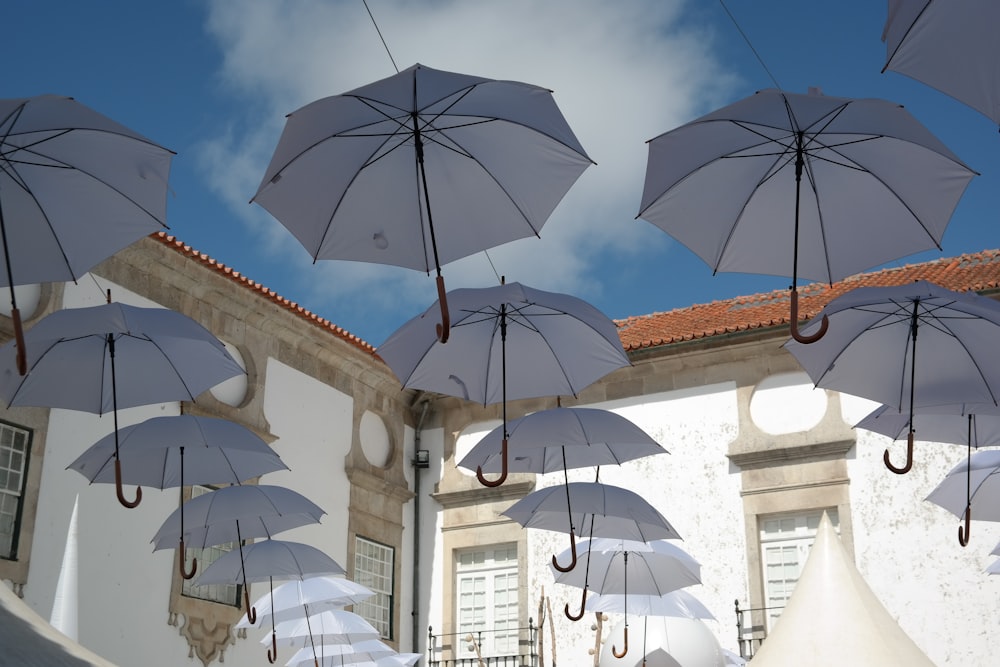 a group of white umbrellas hanging from a roof