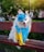 A stylish dog wearing a fashionable outfit in a sunny park.