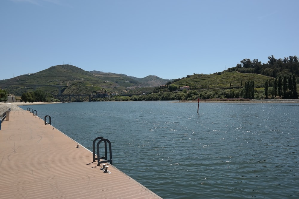 a long wooden dock sitting next to a large body of water