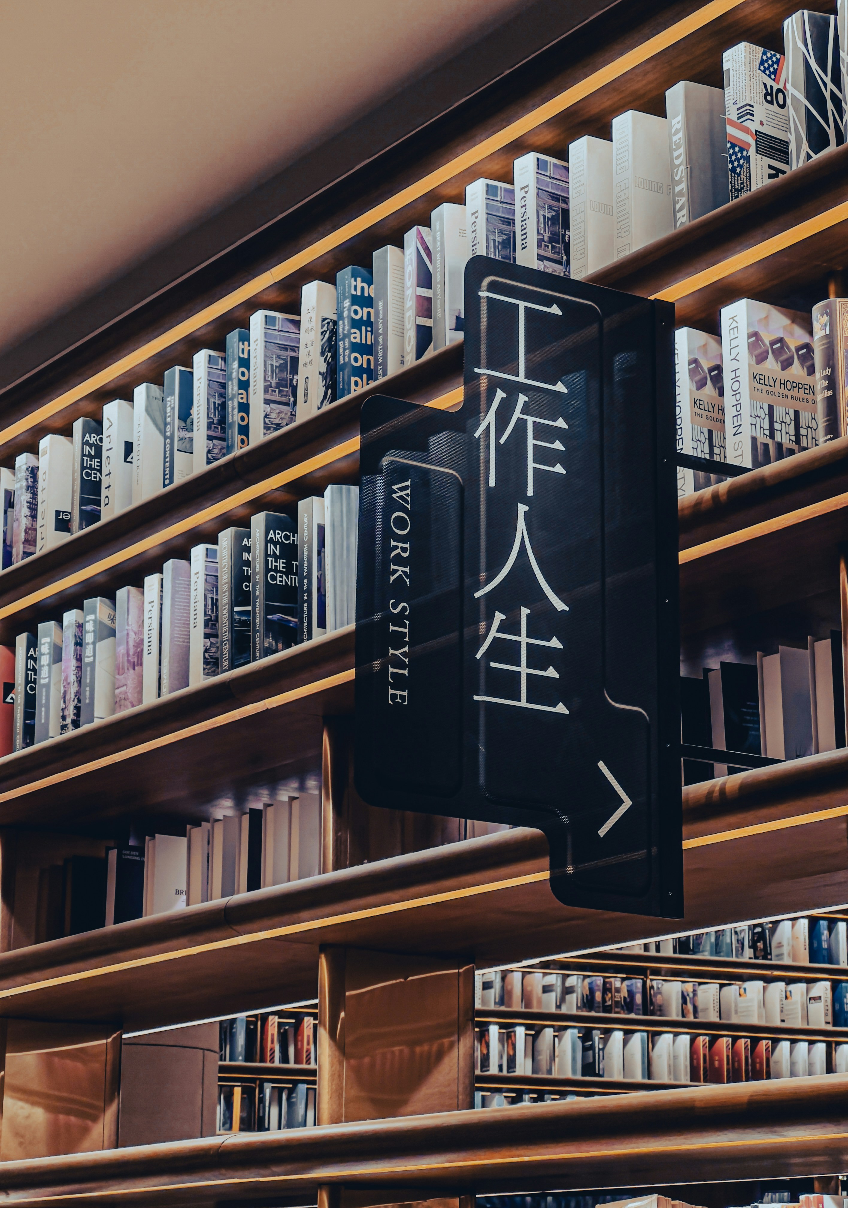 a bookshelf filled with lots of books and a sign