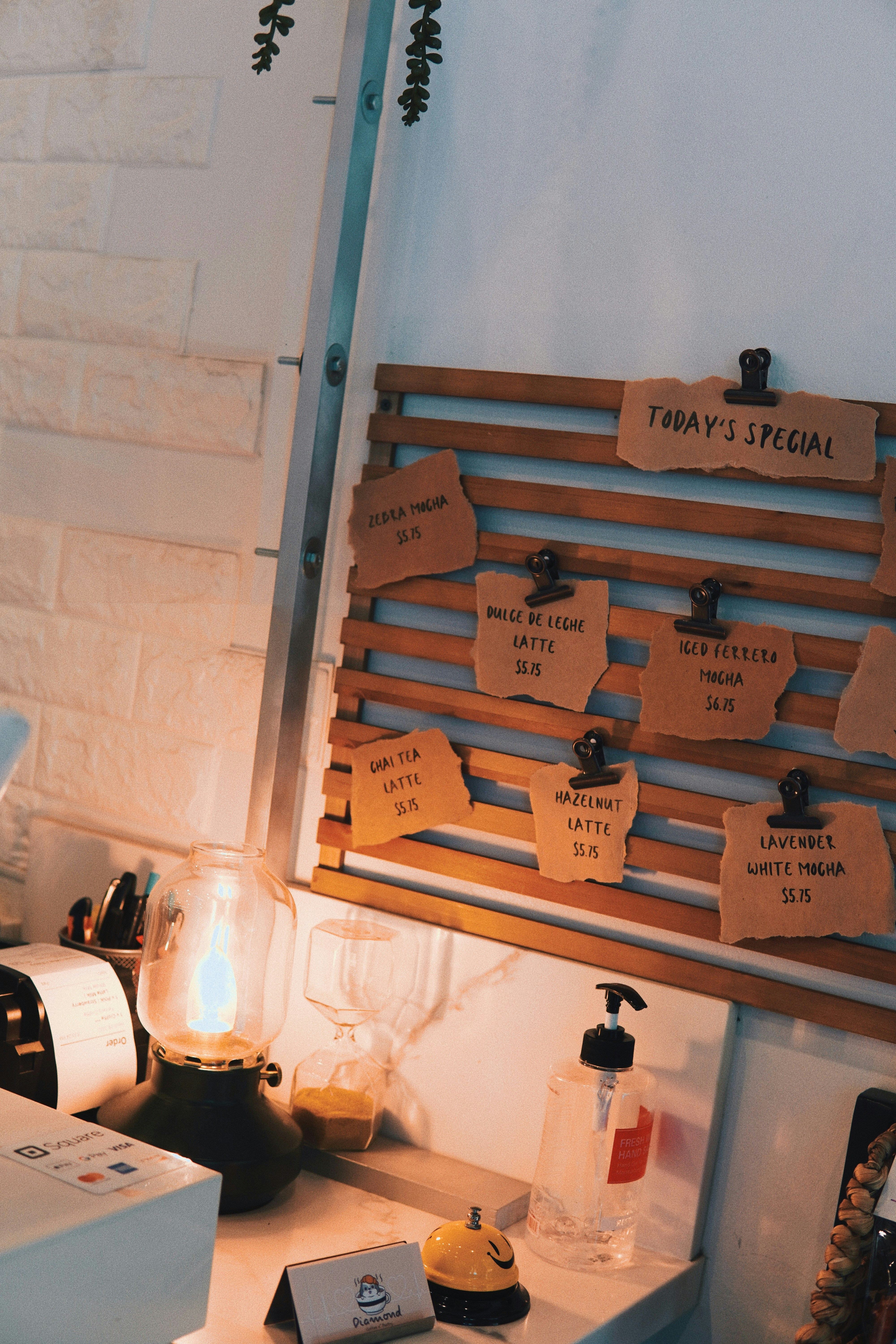Menu board and service items sit on a cafe counter.