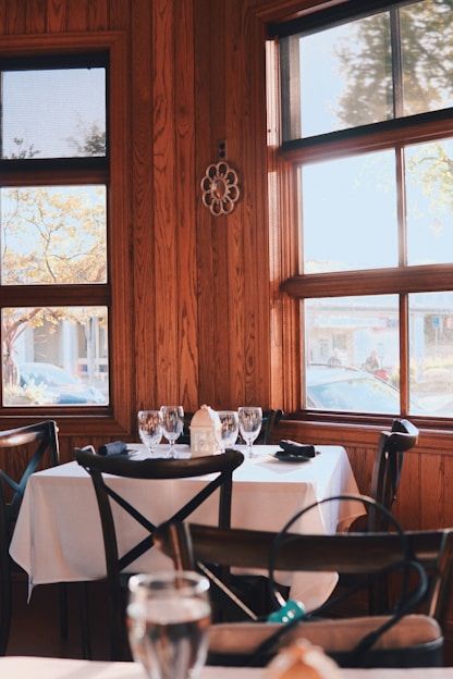 a restaurant with wooden walls and tables and chairs