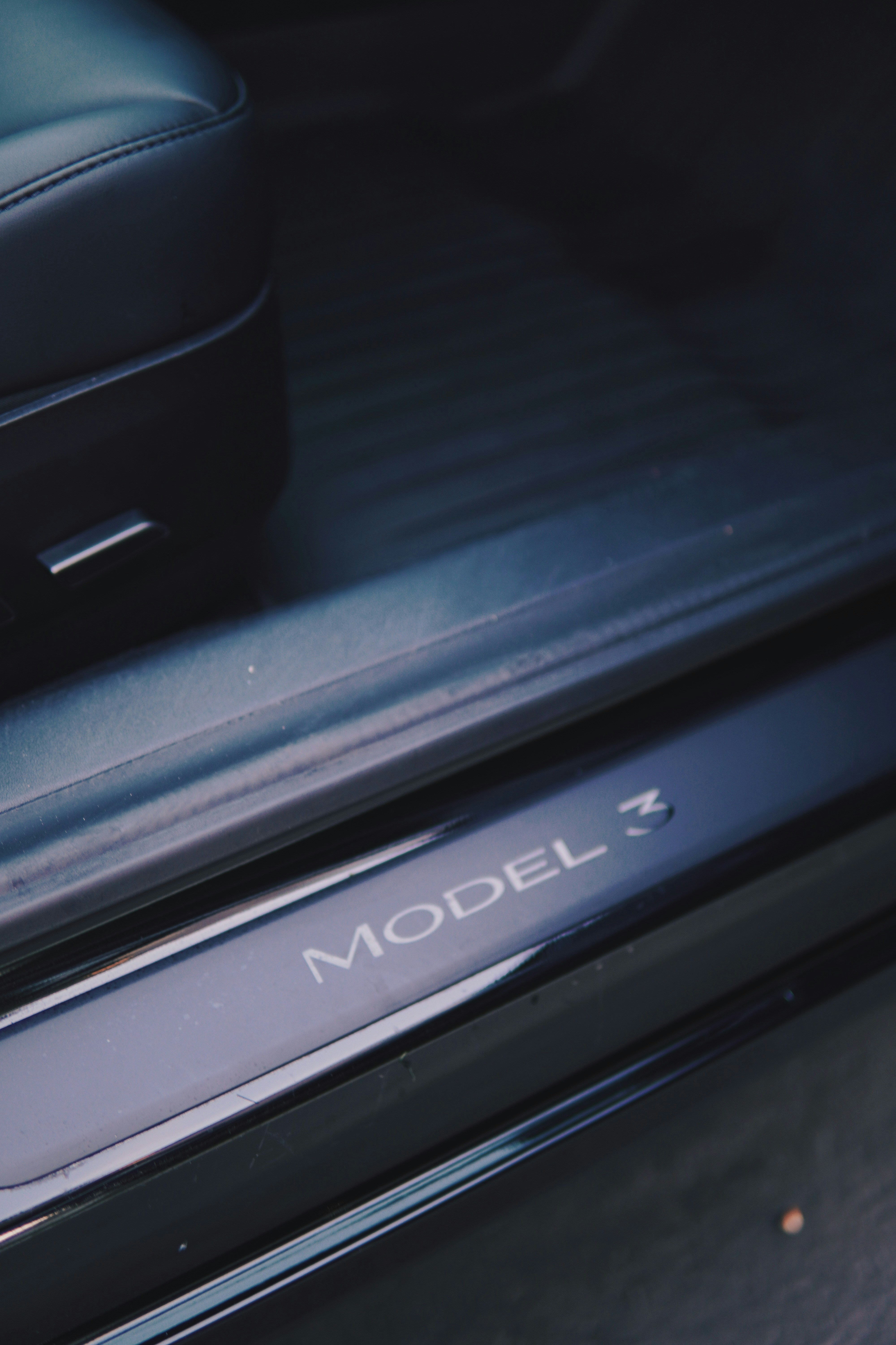 a close up of a car door handle with the word model 3 on it