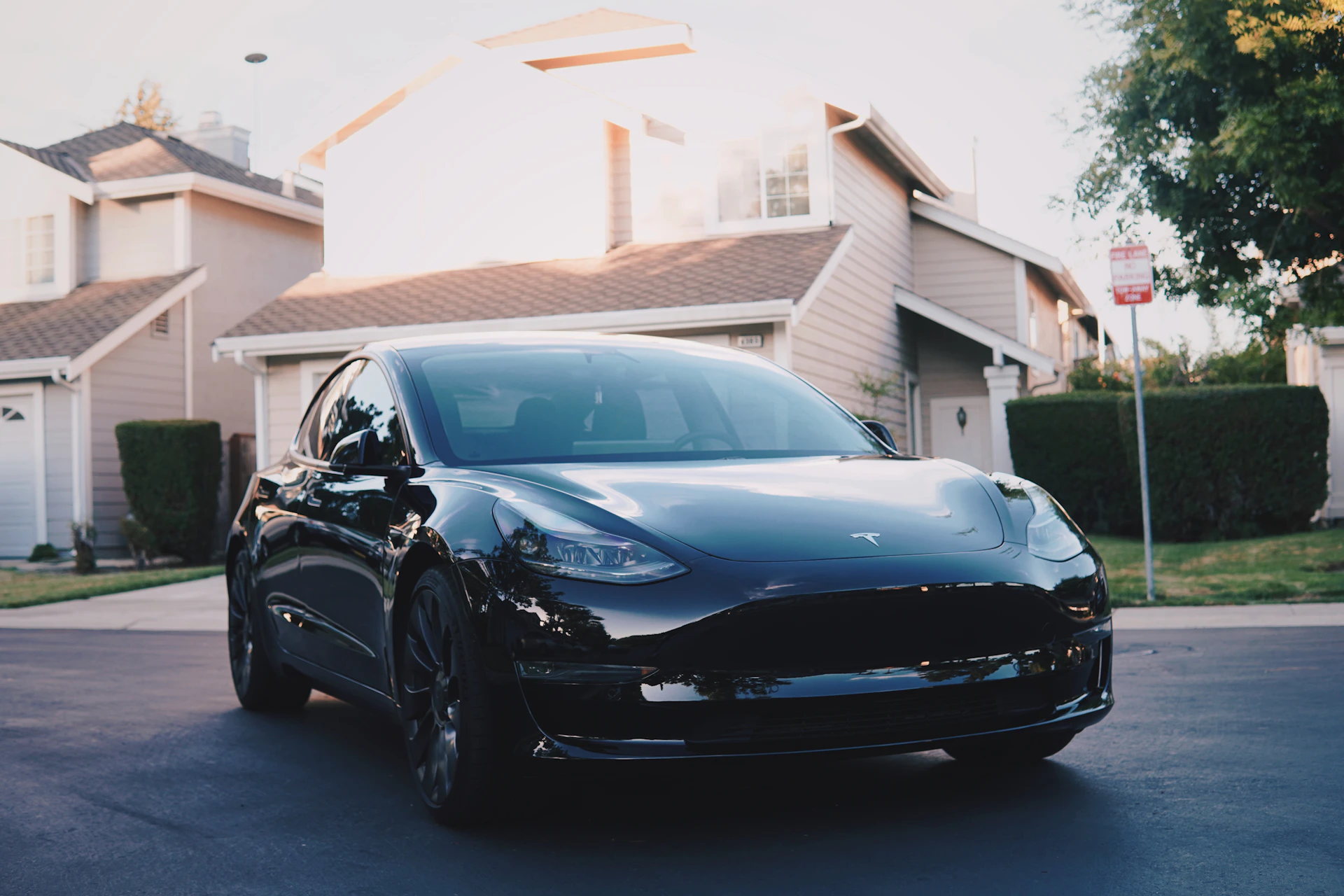 a black car parked in front of a house