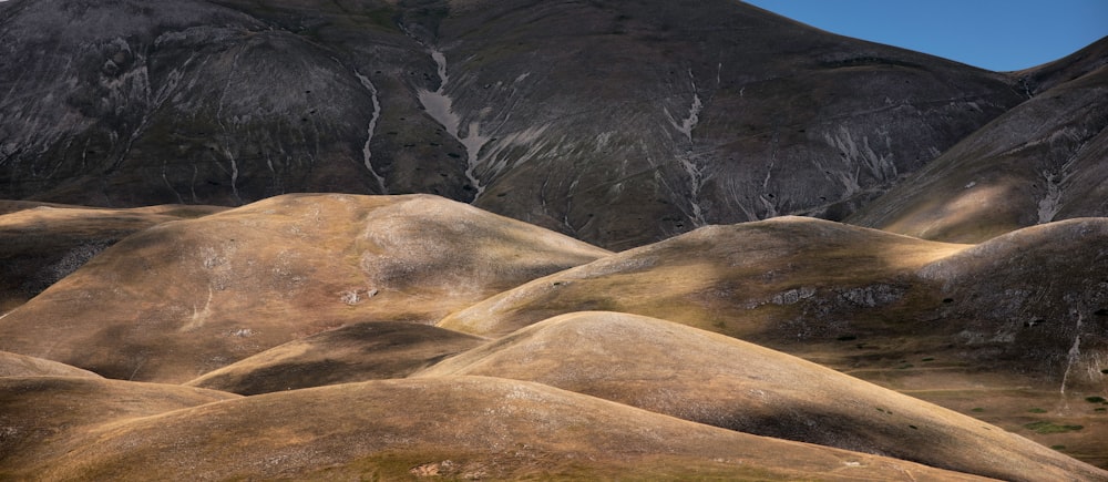 a group of hills with a sky background