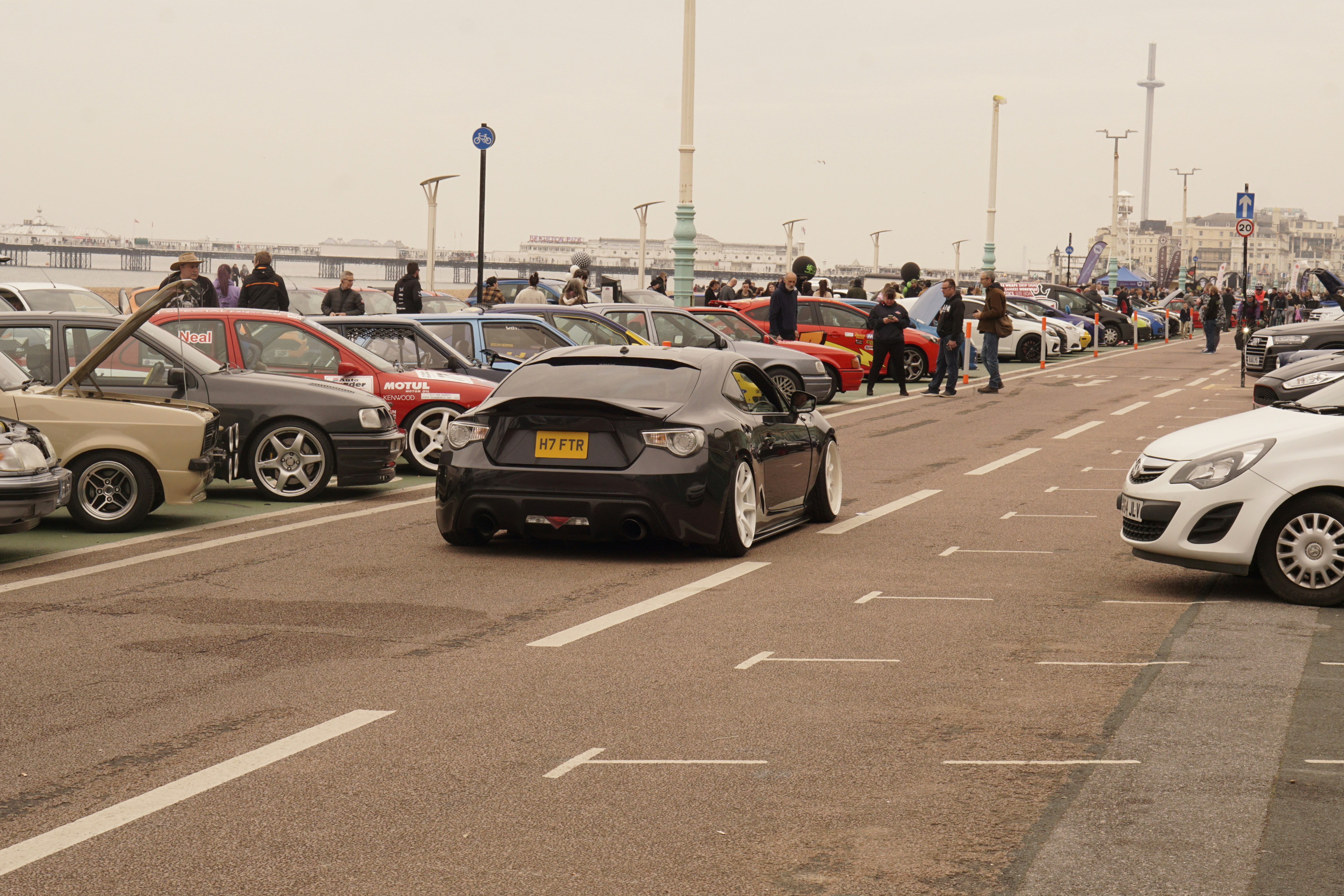 Row of electric cars plugged into public charging stations