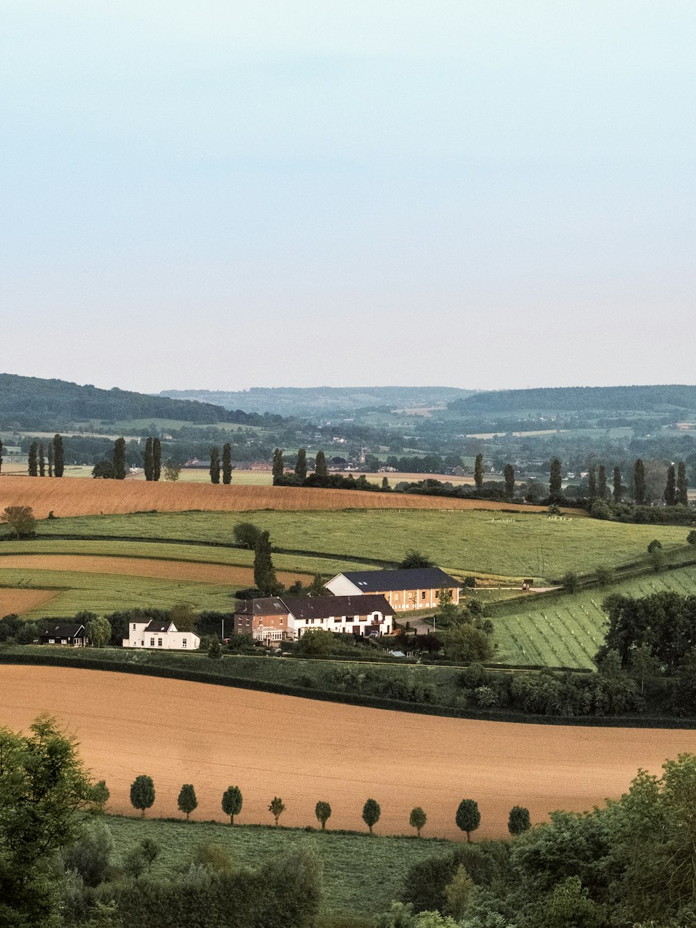 a farm house in the middle of a field