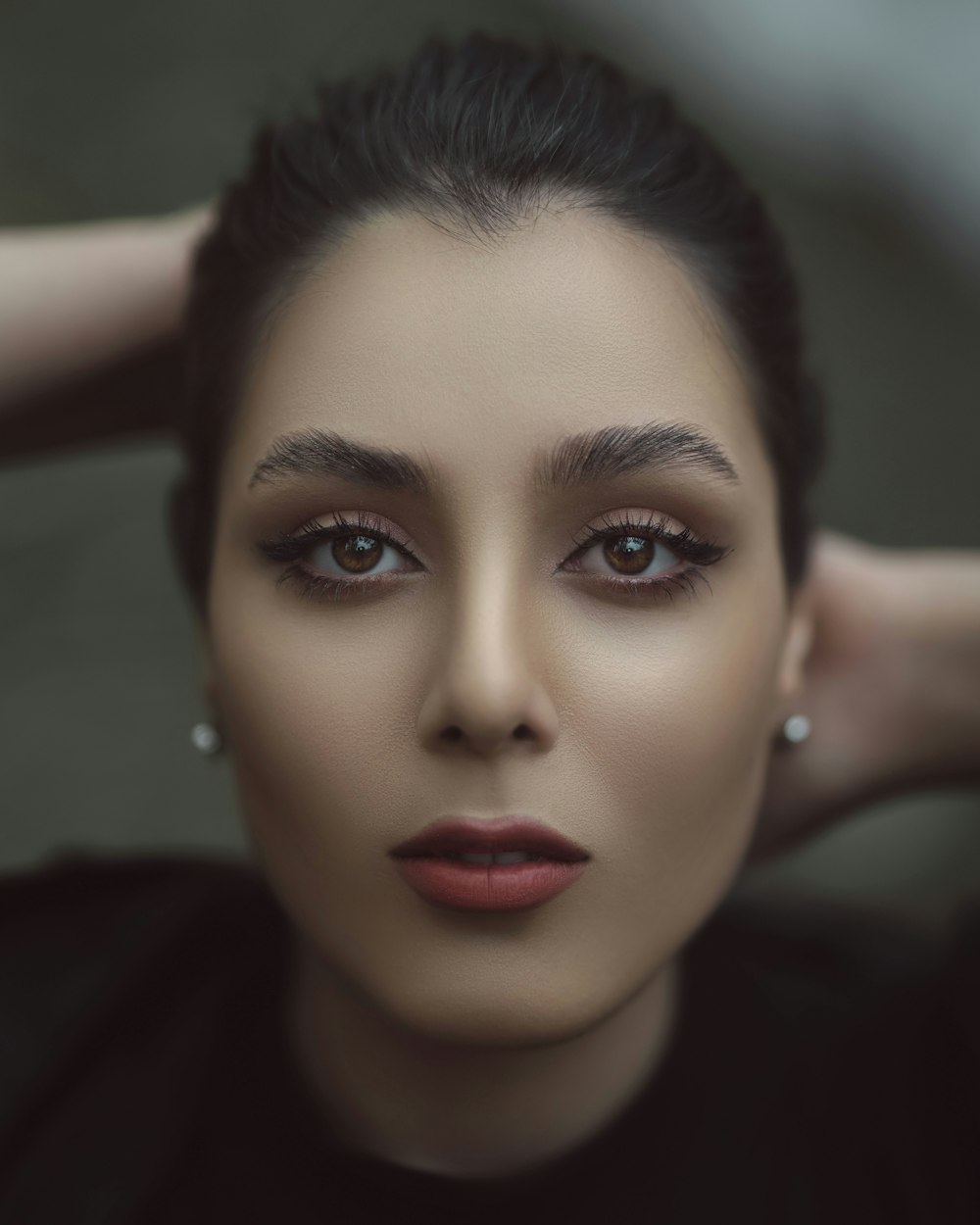 a close up of a woman with dark makeup