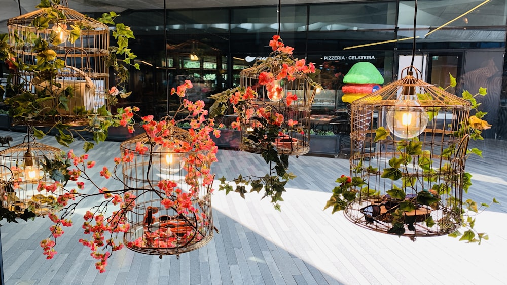 a room filled with lots of bird cages filled with flowers