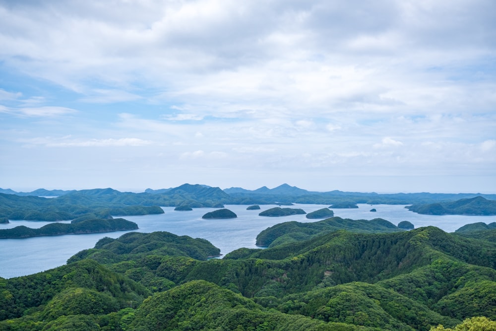 a large body of water surrounded by lush green hills