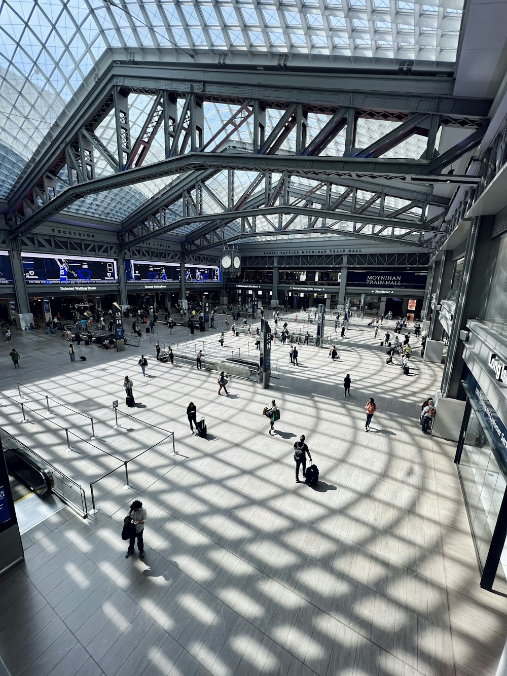 a group of people walking around a train station