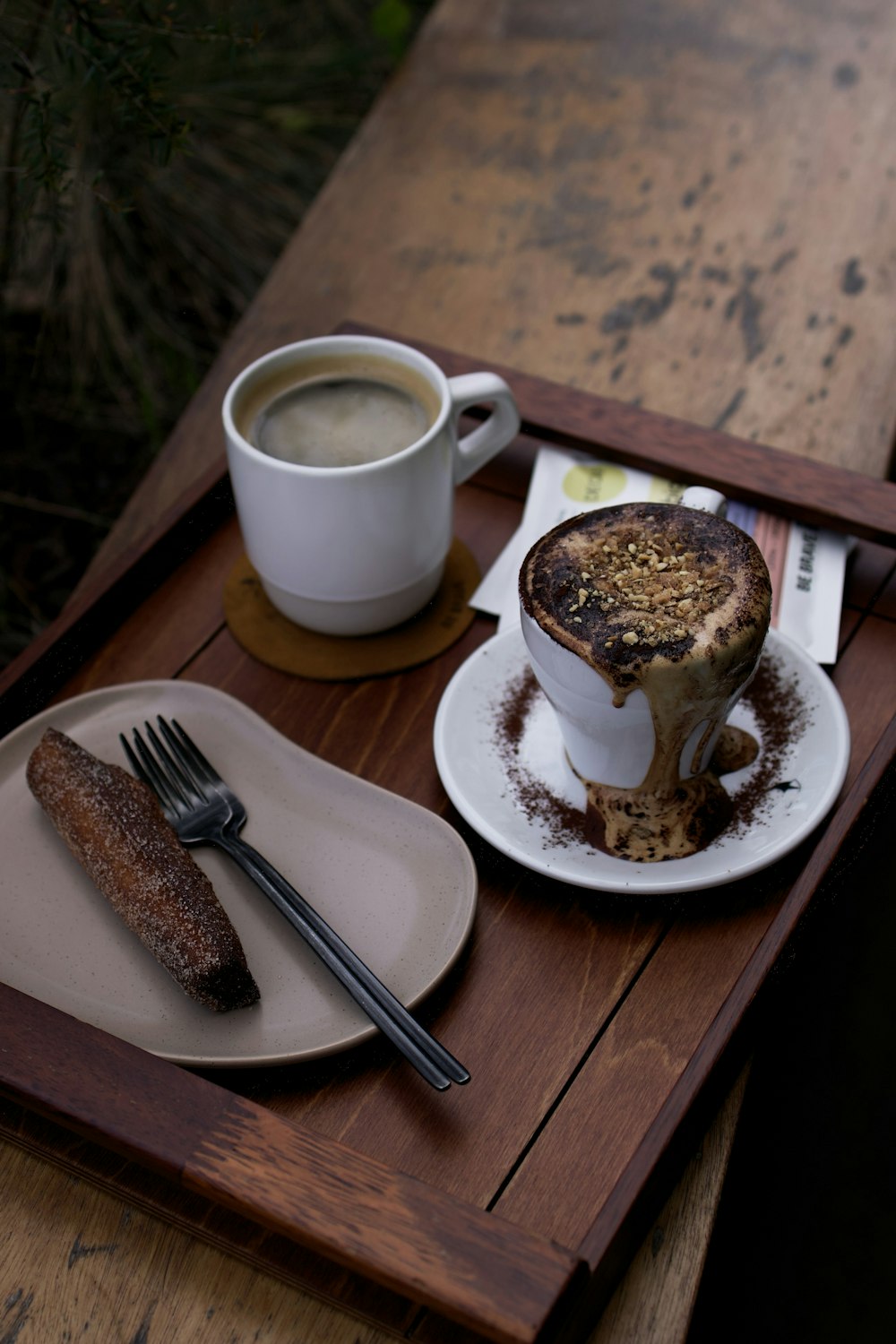 a plate with a desert on it next to a cup of coffee