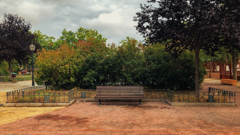 a wooden bench sitting in the middle of a park