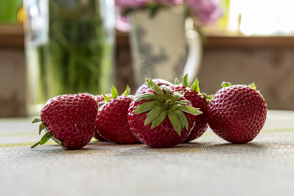 a group of strawberries sitting on top of a table