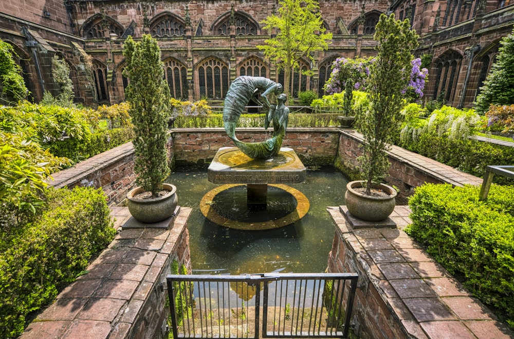 a view of a garden with a statue in the center