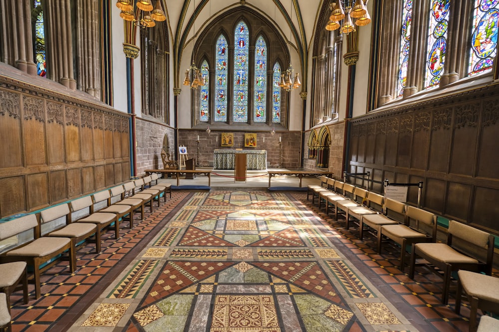 a church with stained glass windows and benches