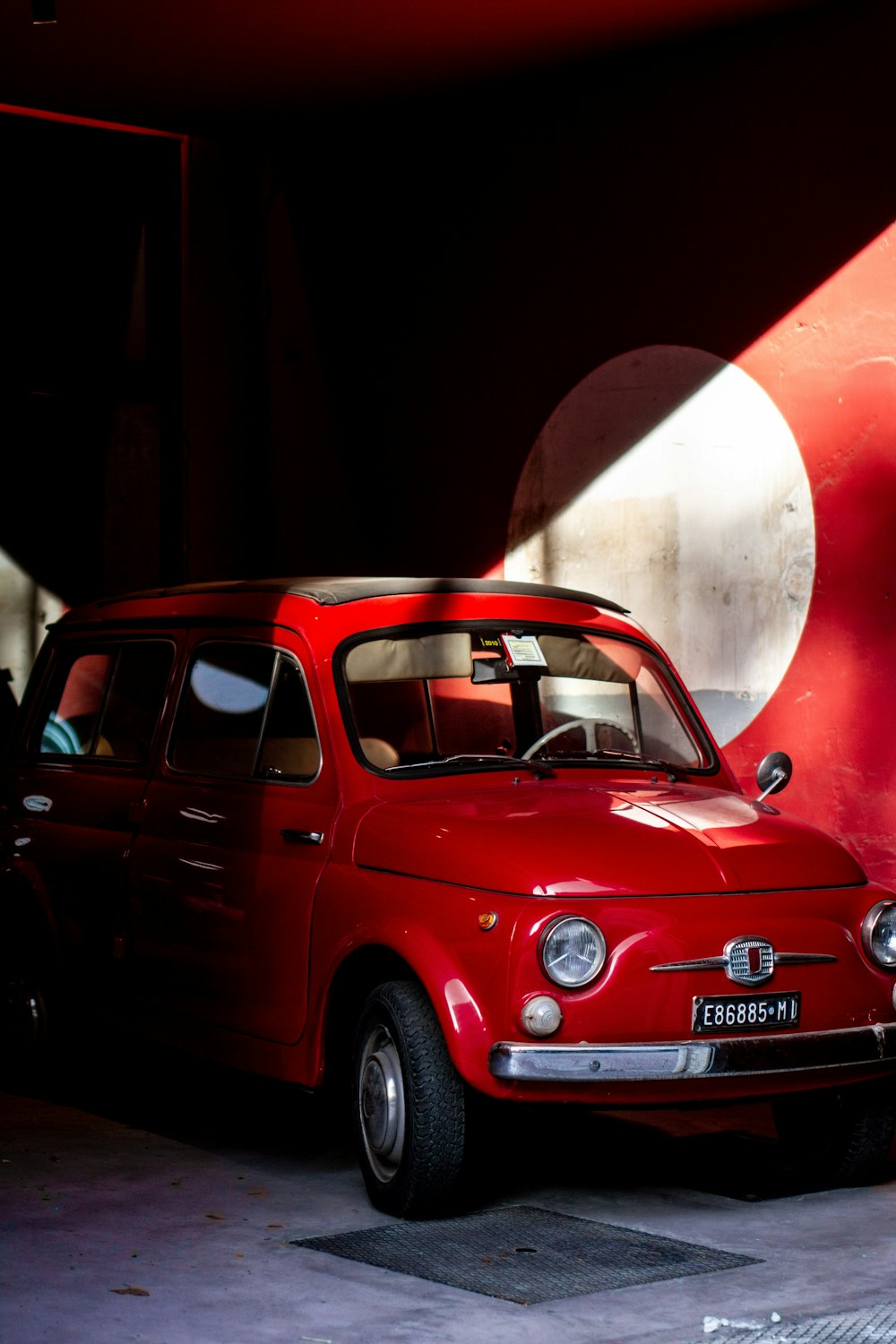 a small red car parked in a garage