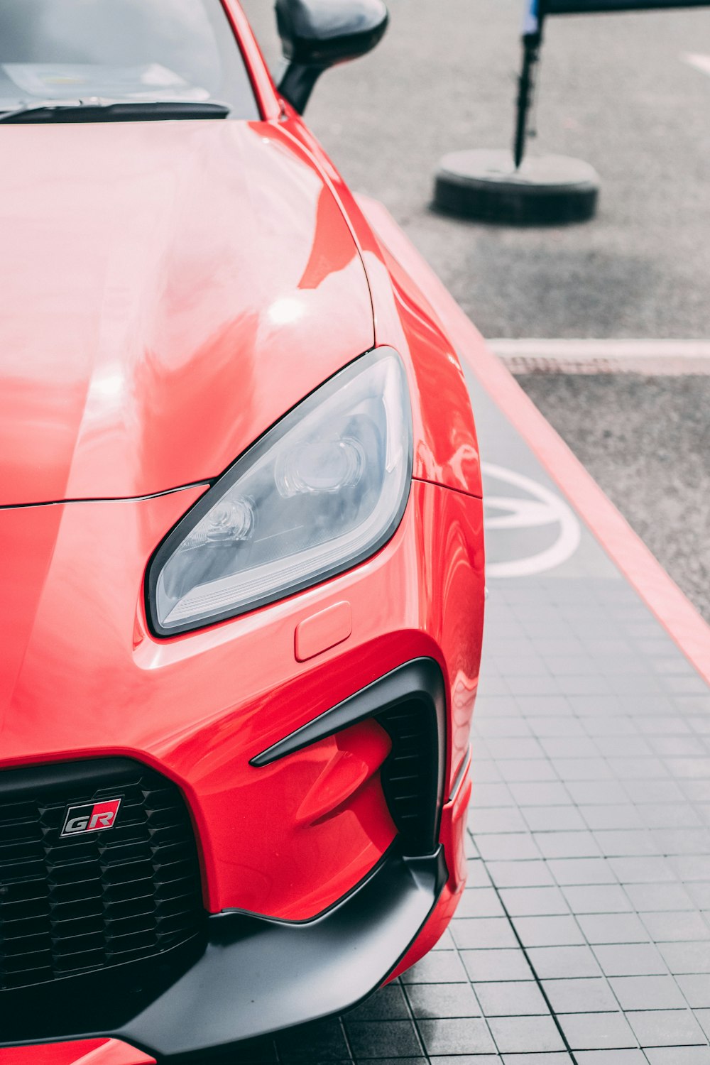 a red sports car parked on the side of the road