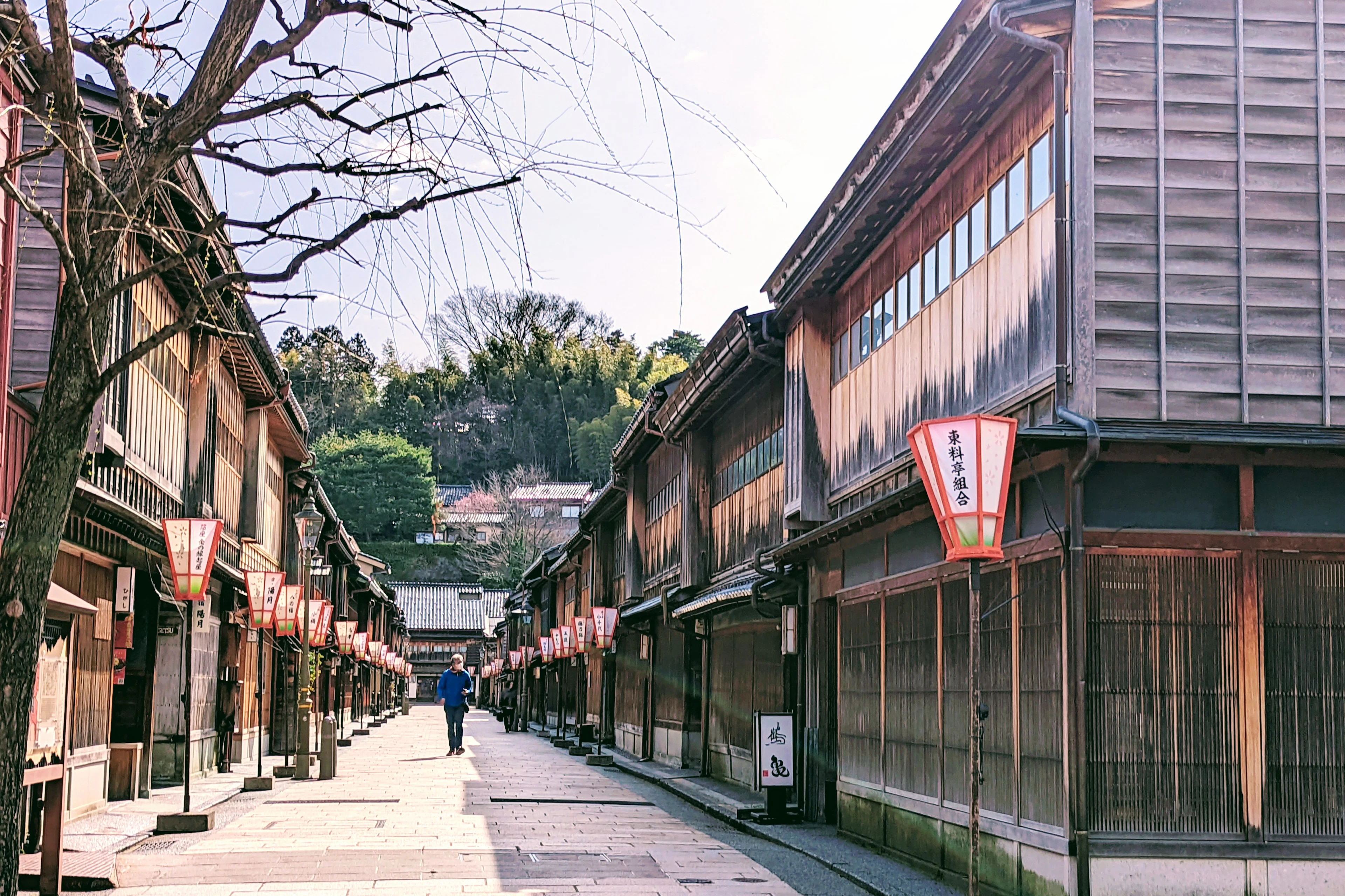 A quiet street of wooden teahouses and red lanterns in the Higashi Chaya district in early spring, Kanazawa