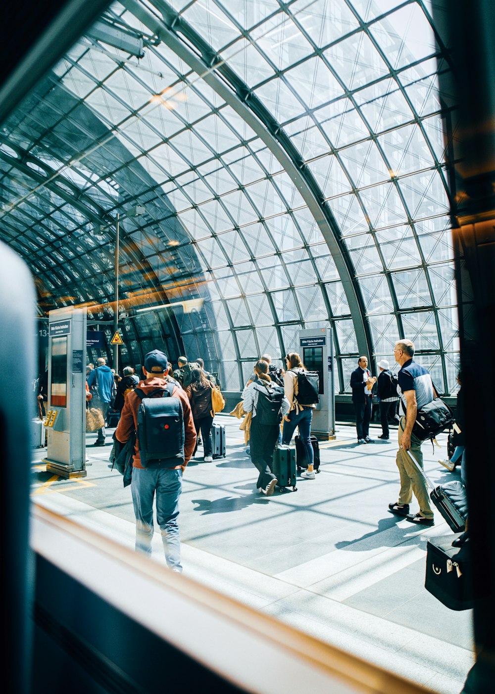 a group of people standing around a train station