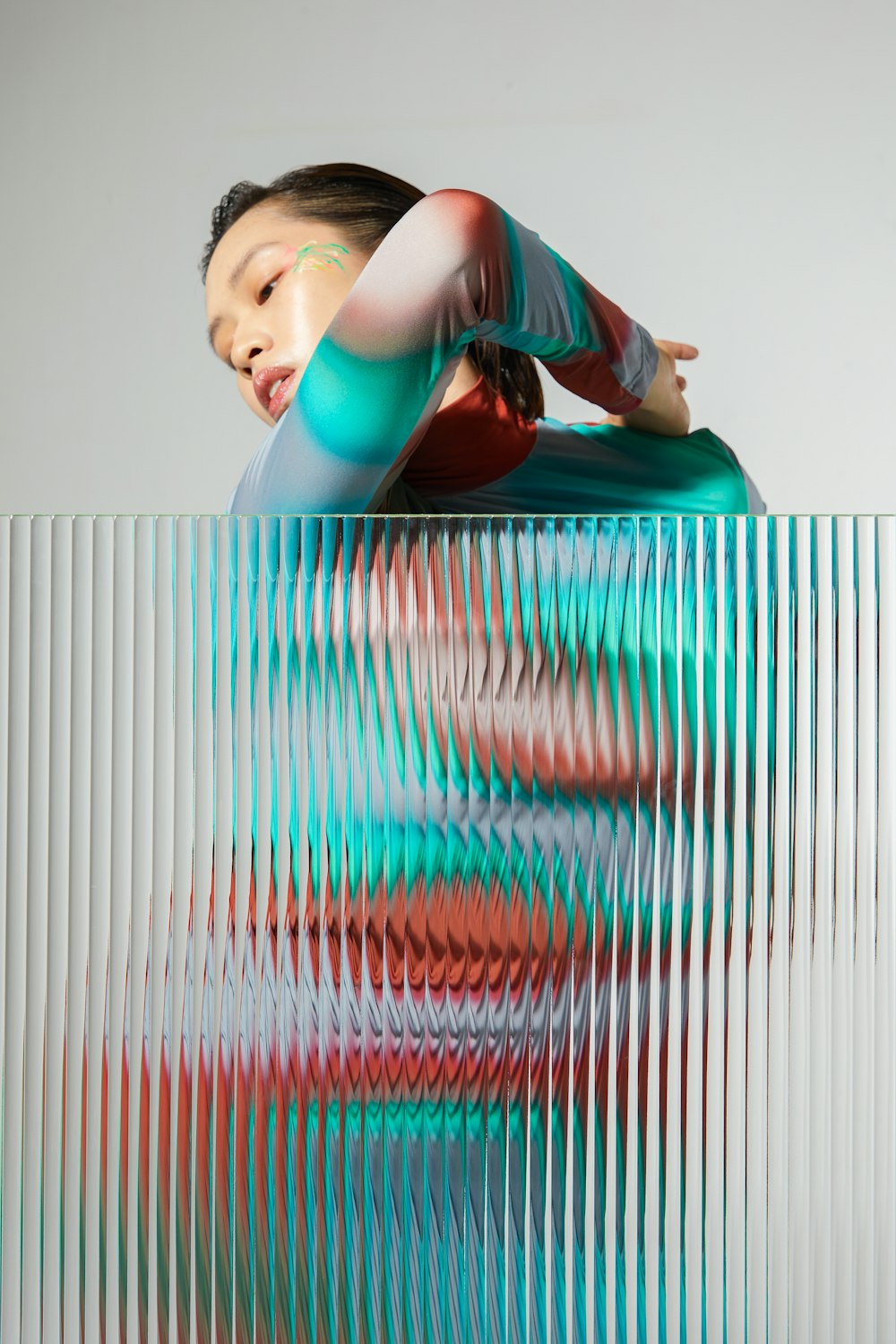 a woman is sitting on a colorful object