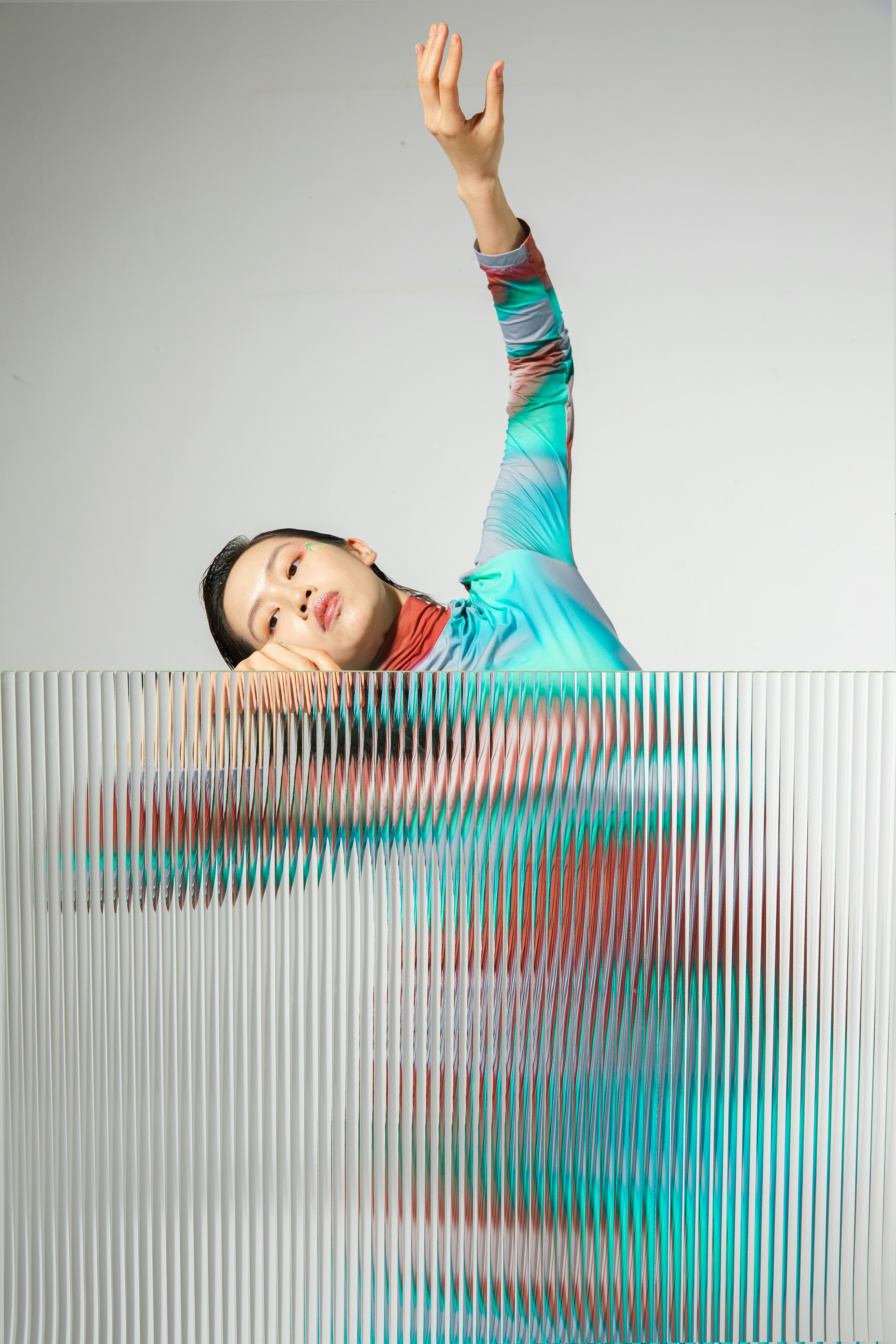 a woman in a blue shirt is doing a trick